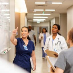 Healthcare workers looking at a whiteboard