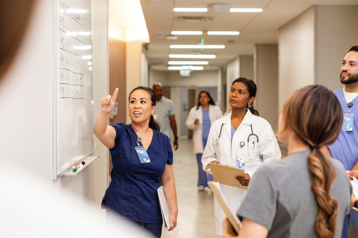 Healthcare workers looking at a whiteboard