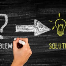 Chalkboard with "problem" and an arrow pointing to "solution."